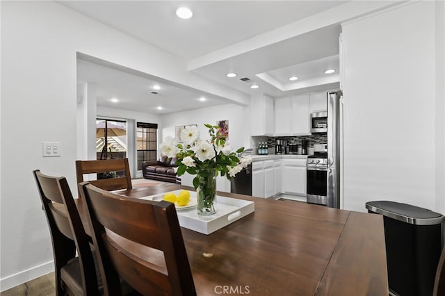 dining space with dark wood-type flooring