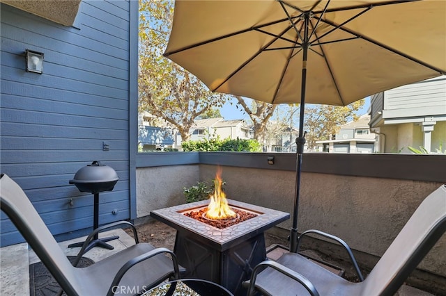 view of patio / terrace featuring an outdoor fire pit