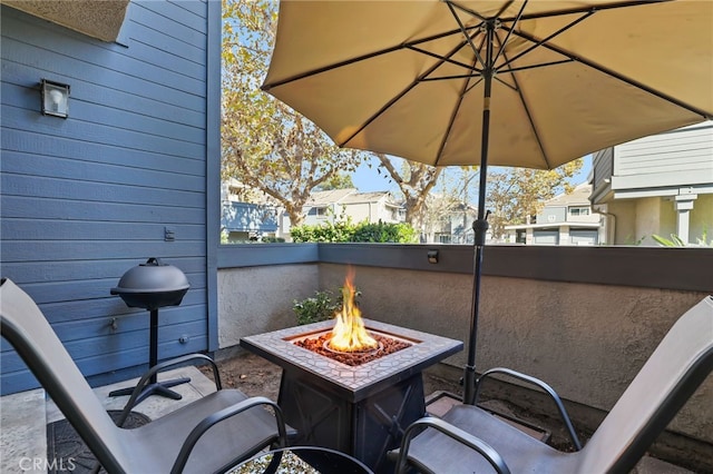 view of patio with a fire pit