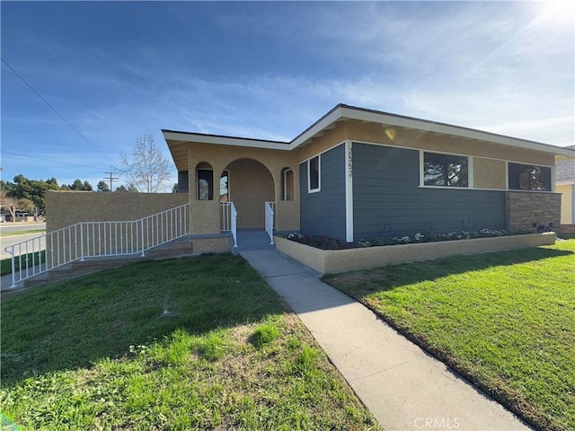 view of front of house featuring a front yard and stucco siding