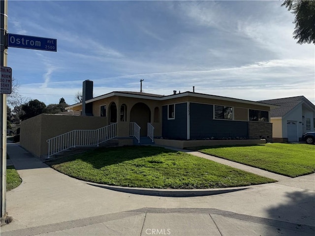 view of front facade with a front yard and a garage