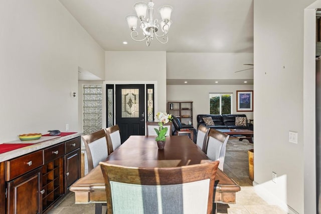 dining room featuring light tile patterned floors and ceiling fan with notable chandelier