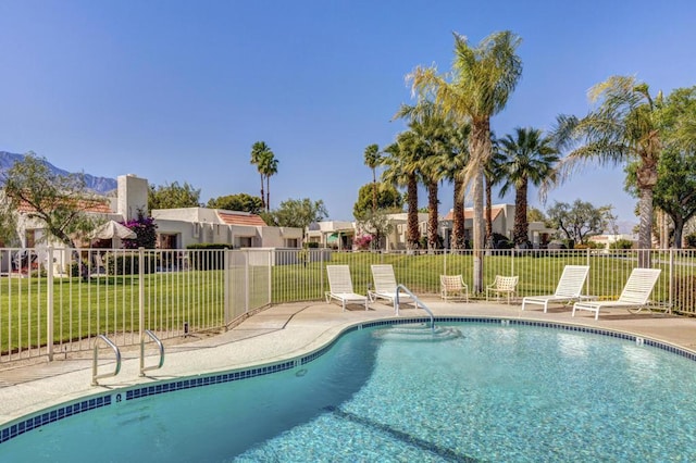 view of swimming pool with a lawn and a patio