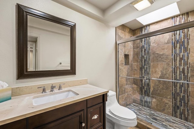 bathroom with toilet, walk in shower, and vanity