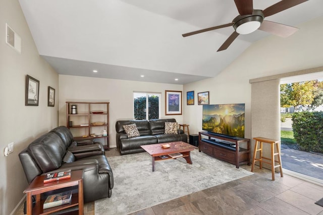 living room featuring ceiling fan, plenty of natural light, and lofted ceiling