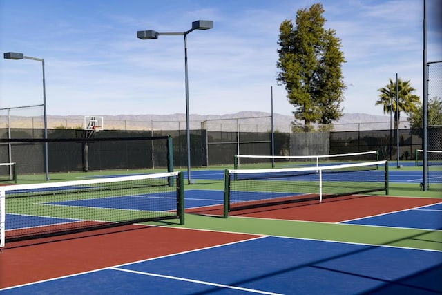 view of tennis court featuring a mountain view and basketball court