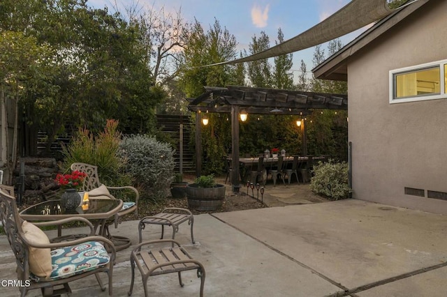 patio terrace at dusk with a pergola