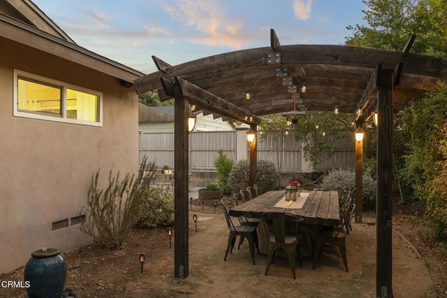 patio terrace at dusk with a pergola