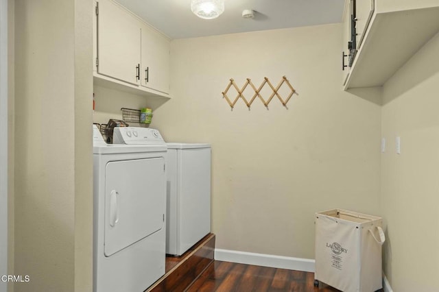 laundry area with cabinets, dark wood-type flooring, and washer and dryer