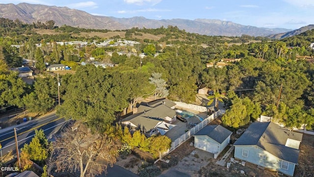 birds eye view of property with a mountain view and a view of trees