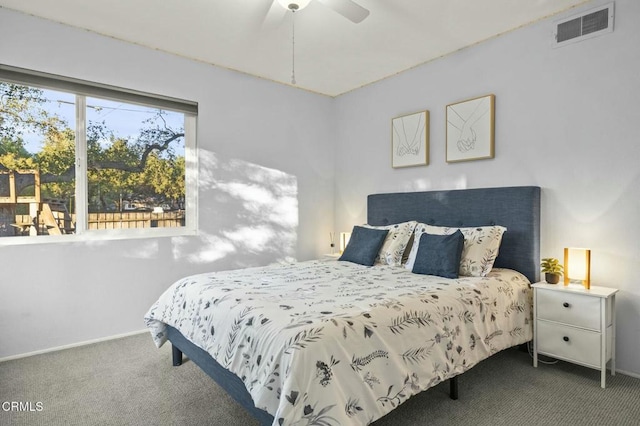 carpeted bedroom with visible vents, ceiling fan, and baseboards