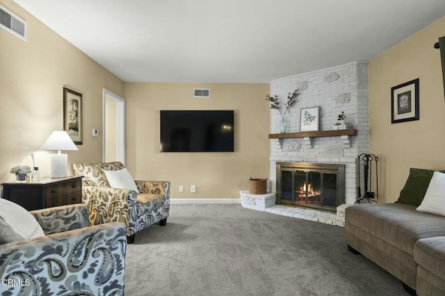 carpeted living room featuring baseboards, a fireplace, and visible vents