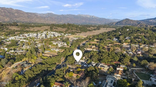 birds eye view of property featuring a mountain view