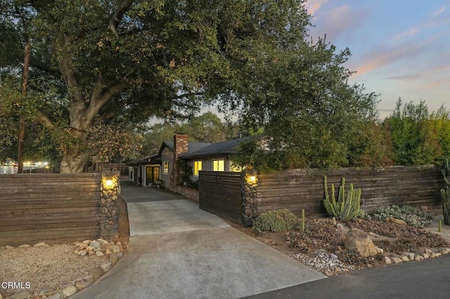 view of front of house featuring a fenced front yard and a chimney