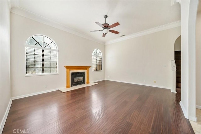 unfurnished living room with ceiling fan, dark hardwood / wood-style floors, and ornamental molding