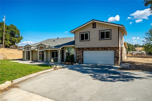 tri-level home with a garage and a front yard