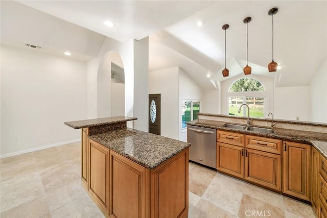 kitchen with pendant lighting, dishwasher, lofted ceiling, dark stone counters, and sink