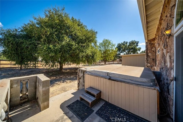 view of patio / terrace with a hot tub