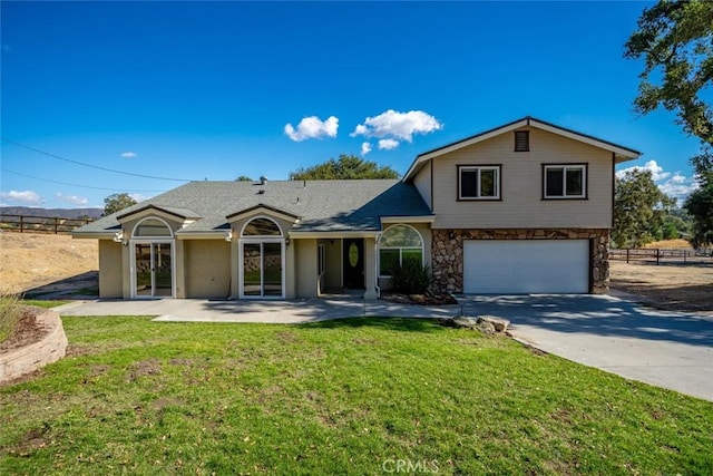 split level home featuring a garage and a front lawn