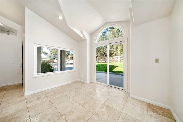 tiled empty room with vaulted ceiling