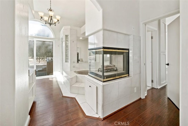 corridor featuring a notable chandelier and dark hardwood / wood-style floors