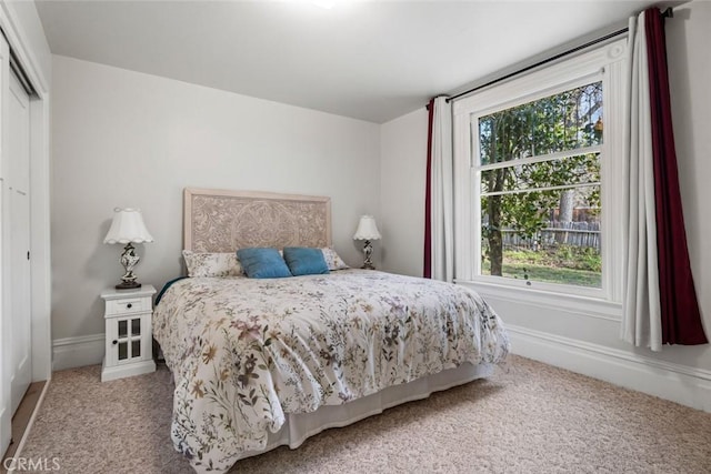 carpeted bedroom featuring multiple windows