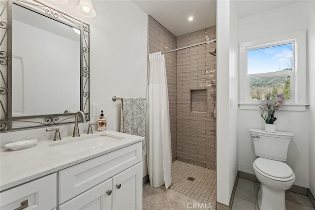 bathroom featuring toilet, vanity, a shower with curtain, and tile patterned flooring