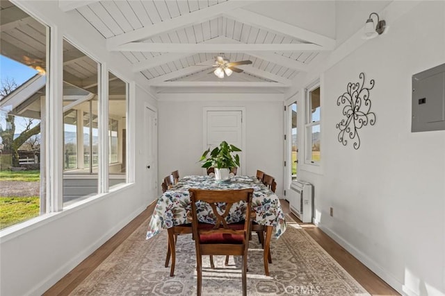 dining area with ceiling fan, dark hardwood / wood-style floors, lofted ceiling with beams, and electric panel