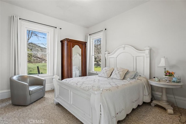 carpeted bedroom featuring multiple windows