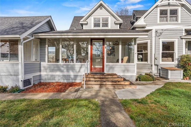 view of front of house featuring a front lawn and a sunroom