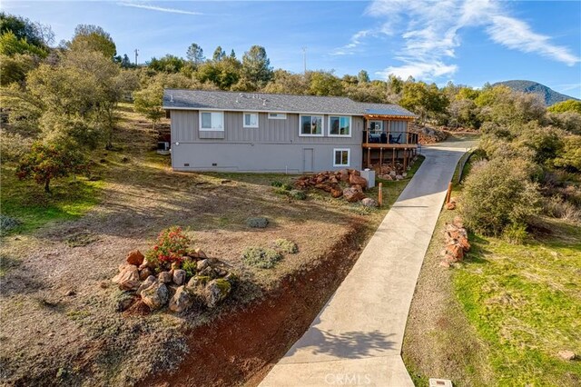 view of front of property with a deck with mountain view