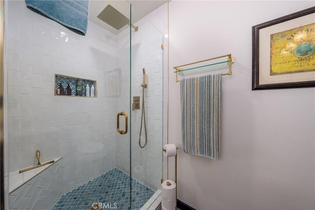 bathroom featuring a shower with door