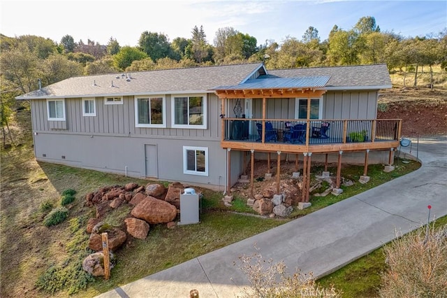 back of property with a wooden deck