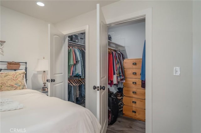 bedroom with wood-type flooring and a closet