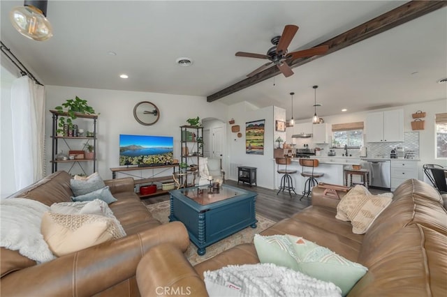 living room with ceiling fan, dark hardwood / wood-style floors, lofted ceiling with beams, and sink