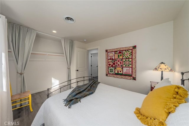 bedroom featuring wood-type flooring and a closet