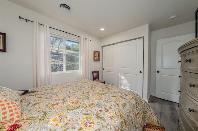 bedroom with a closet and hardwood / wood-style floors