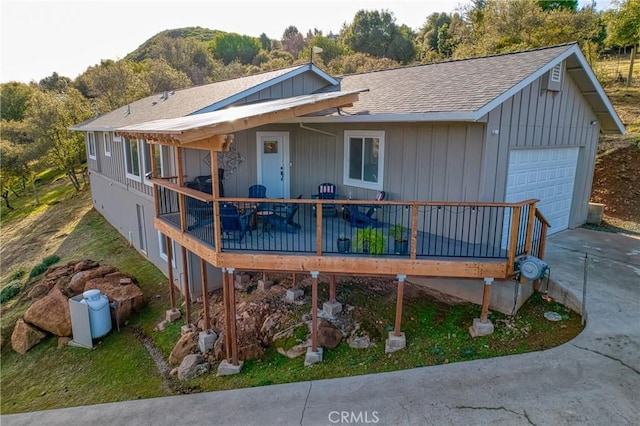 rear view of property with a garage