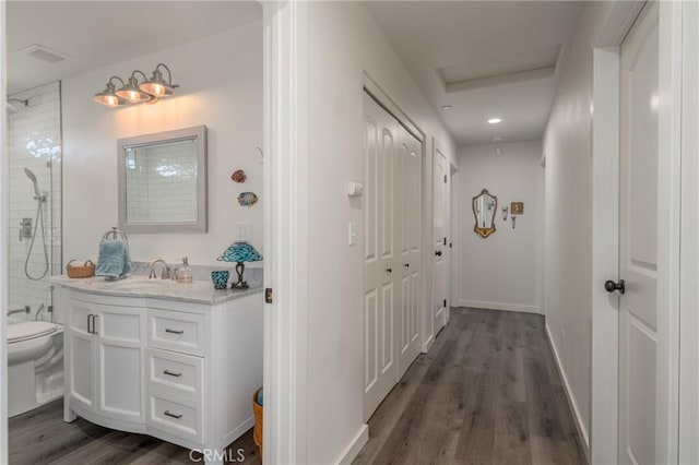 hall featuring sink and dark hardwood / wood-style flooring