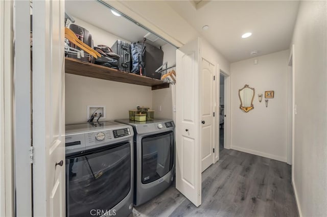 laundry area featuring dark hardwood / wood-style floors and washing machine and clothes dryer