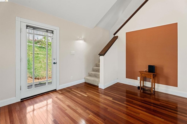 entrance foyer with hardwood / wood-style flooring and lofted ceiling