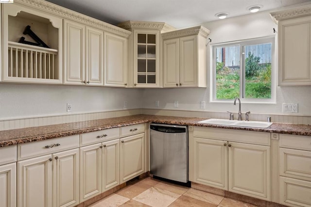 kitchen with light tile patterned floors, dishwasher, sink, and cream cabinets