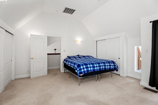 carpeted bedroom featuring lofted ceiling and a closet