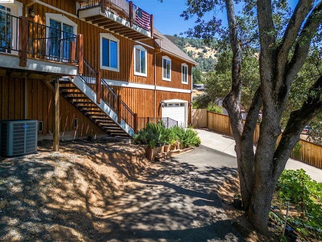 view of front of property with central AC and a garage