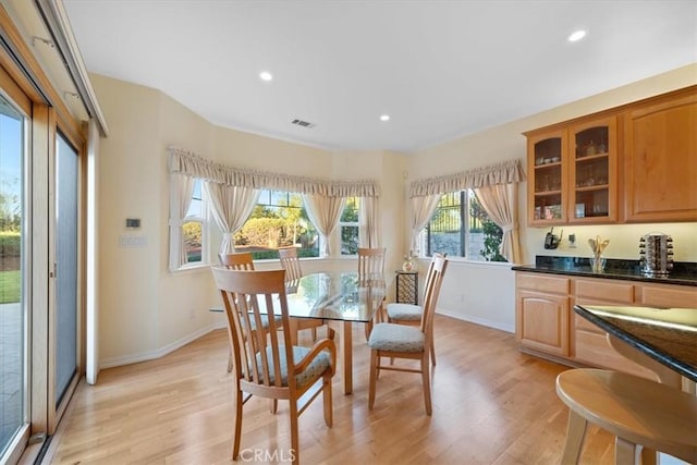 dining area with light hardwood / wood-style floors