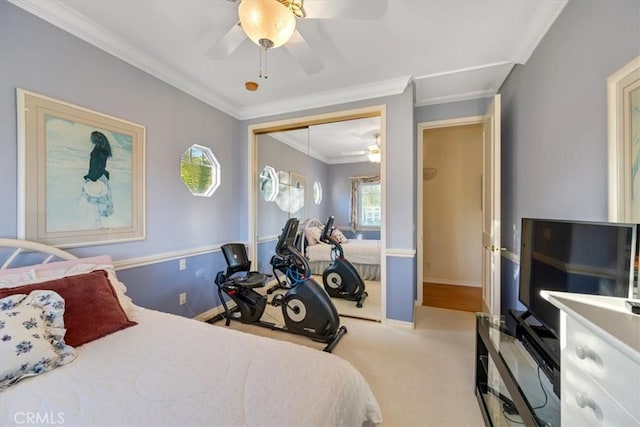 carpeted bedroom with ornamental molding, a closet, and ceiling fan