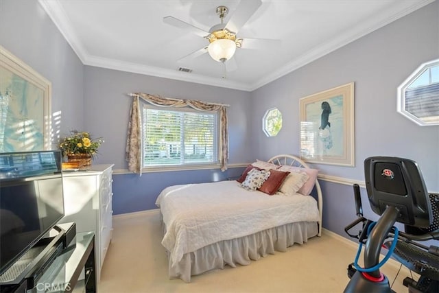 bedroom with ceiling fan, ornamental molding, and light carpet