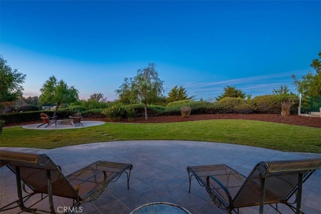 view of swimming pool featuring a fire pit, a yard, and a patio area