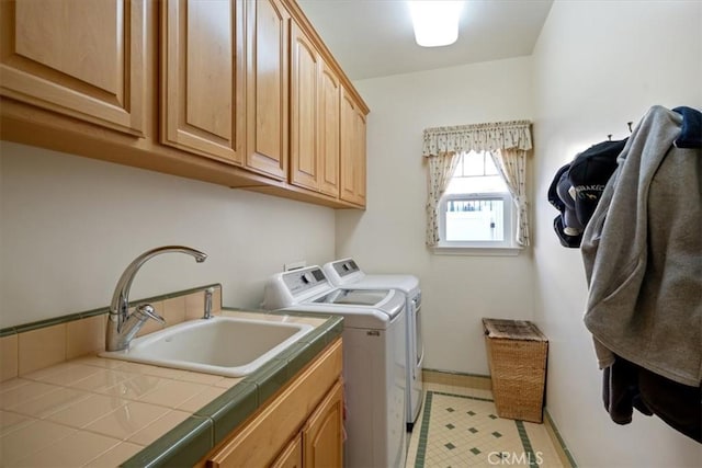 washroom featuring cabinets, separate washer and dryer, and sink