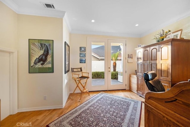 doorway featuring french doors, crown molding, and light hardwood / wood-style floors